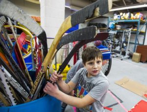 A photo of Pierce holding a hockey stick
