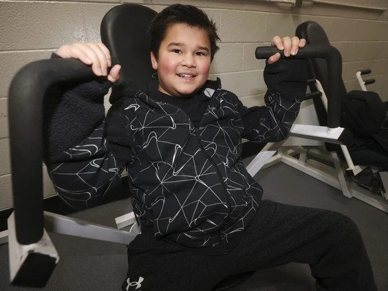 George Guinto, 12, works out on weight machines with his dad Brian at Variety Village